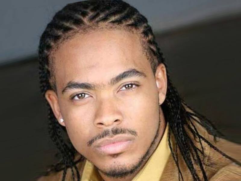An African American man with a cornrows hairstyle.