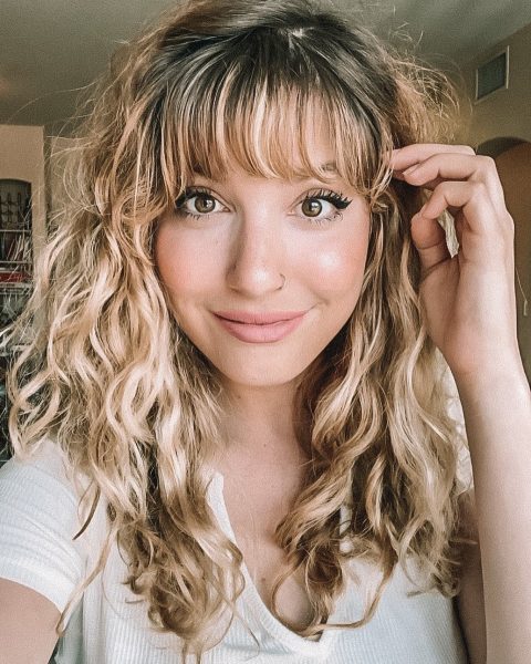 curled hairstyle with side-swept bangs