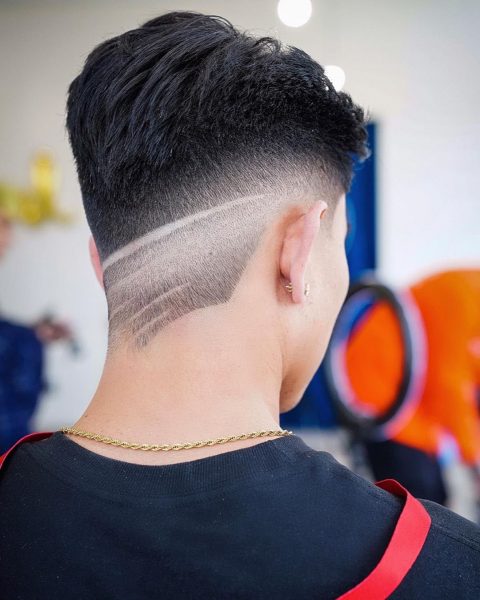 Slicked Back Undercut Design with Fade and Lines for Guys