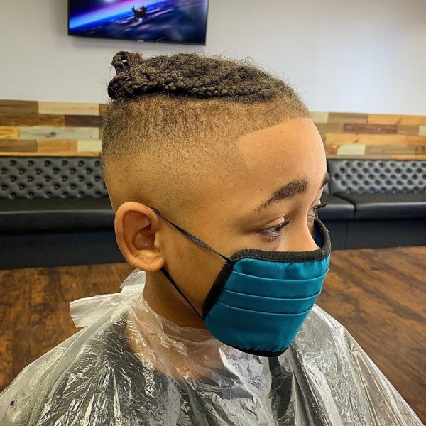 A faded haircut with braids for boys.