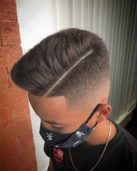 A comb-over faded haircut for boys.