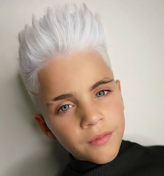 An adventurous brushed-up faded haircut for boys.