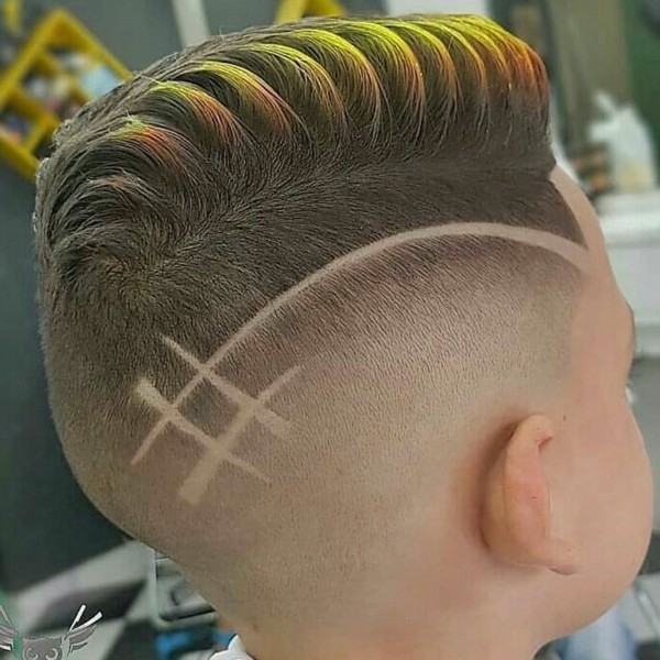 An unsual fade haircut for boys with a line.