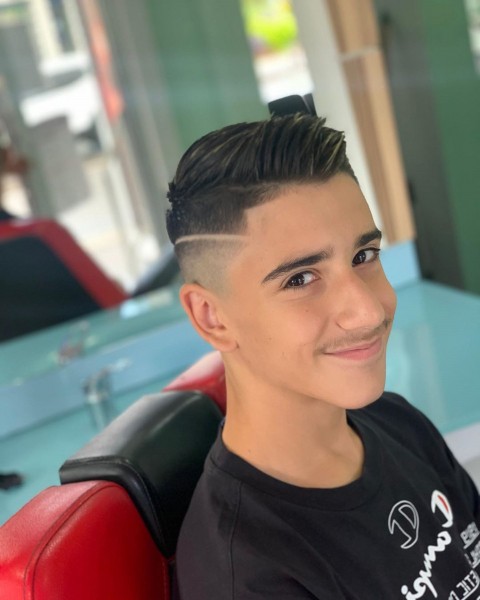 A faded side-part haircut for boys.