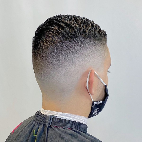 Guy from the back side view with a High Temp Fade Haircut.