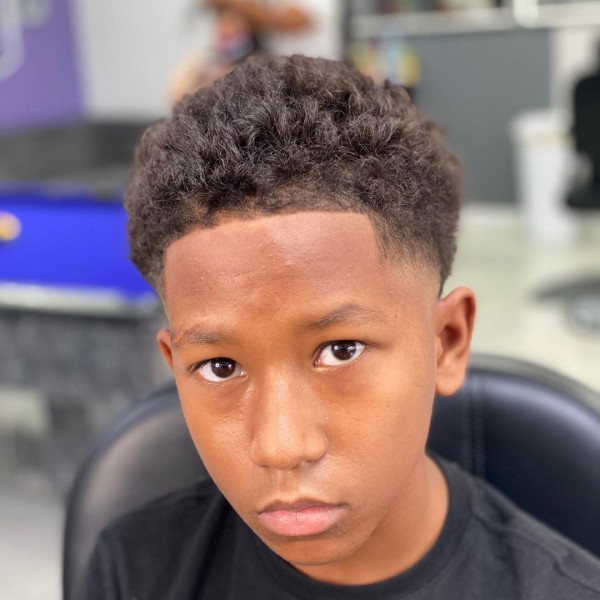 Temp fade Afro hairstyle for young guys.