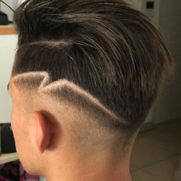 A guy with a Temp Fade with Hair Design.