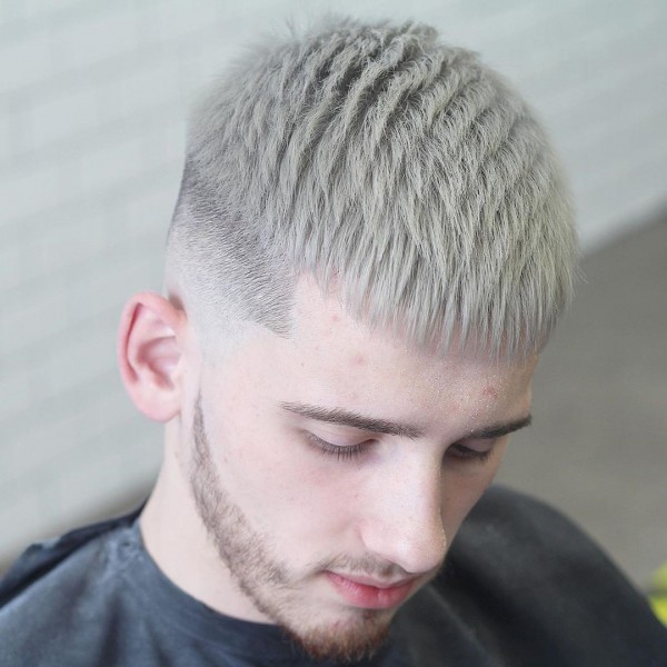 A blonde guy with a temp fade and a short hair crop hairstyle.