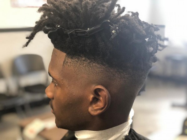 Black men's Temp Fade with Dreads and a pin.