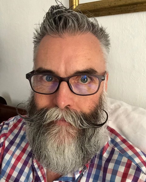 A bearded style with handlebar mustache.