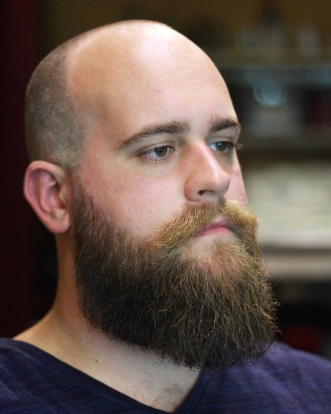 A full beard with a buzz haircut.