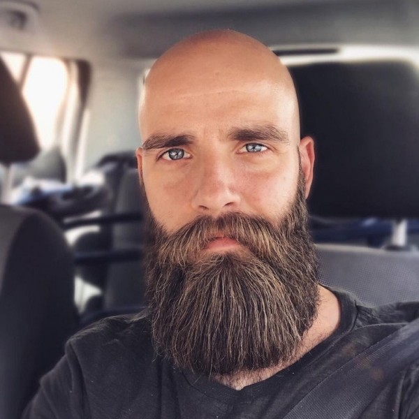 A full beard for men with the shaved haircut.