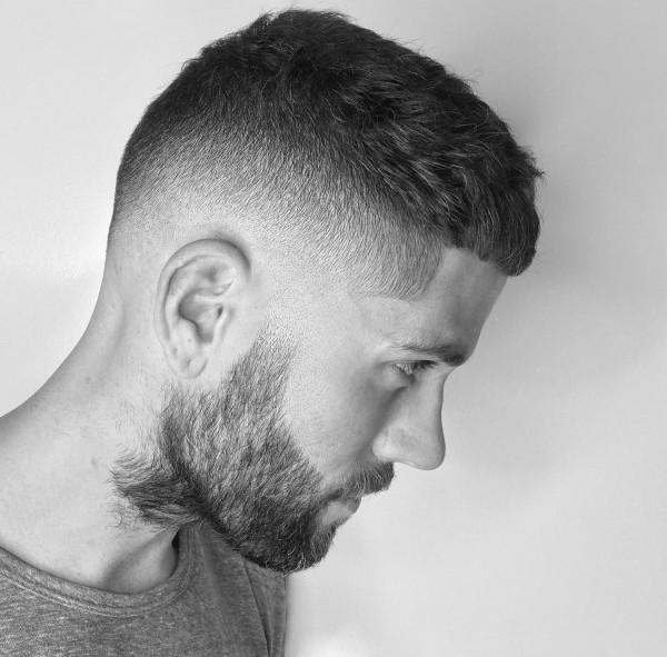 A short beard style for men with a very short hair.