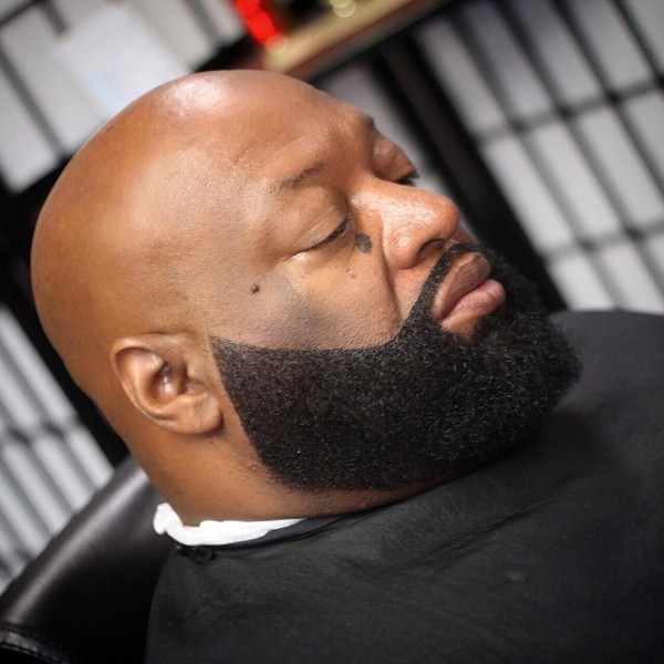 A bald black man with a stylish beard. 