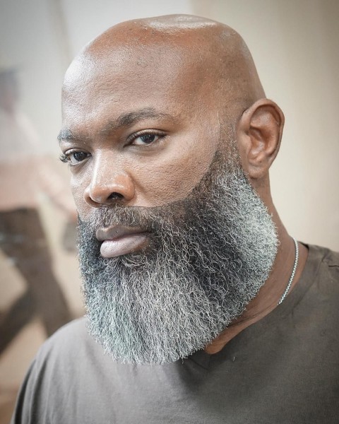 A black man with a salt and pepper beard.