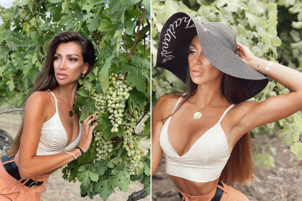 Julia with a big hat and romantic long hairstyle near the grape