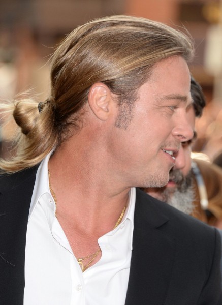 Brad Pitt wearing a fashionable bun style.
