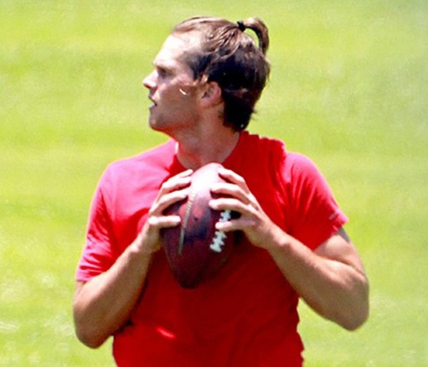 Tom Brady's new hairstyle with a bun.