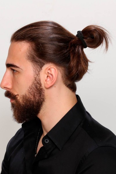 A man bun style for brown hair.