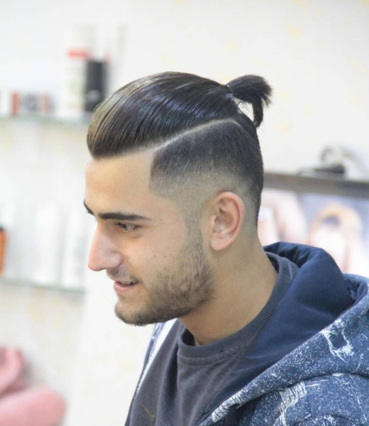 A disconnected bun haircut for men.