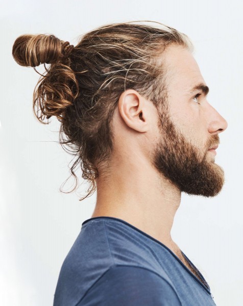 A man with a half bun hairstyle.