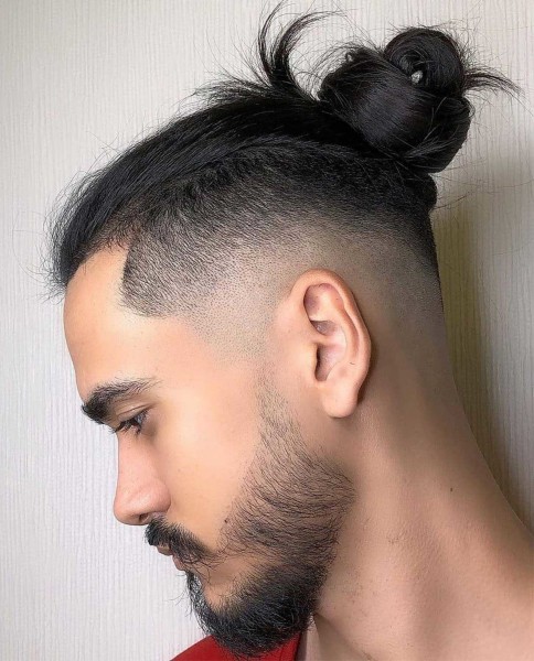 A male blowout hairstyle with a bun