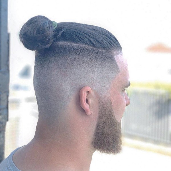 A male bun hairstyle with a comb over.