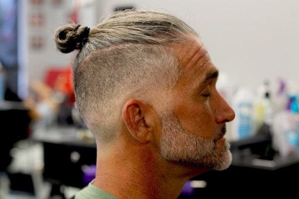 A skin faded haircut with a bun for stylish men.