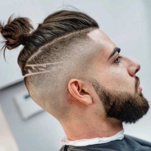 A male bun with the taper fade hairstyle.