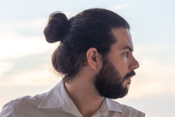 A bun haircut for men with the round face type.