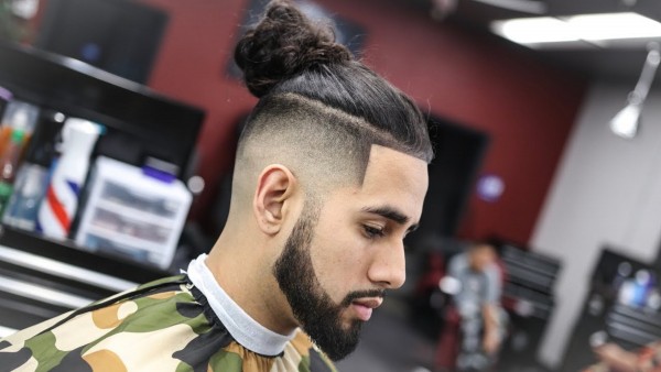 A faded male hairstyle with a bun.
