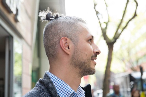 A shaved head hairstyle with a bun.